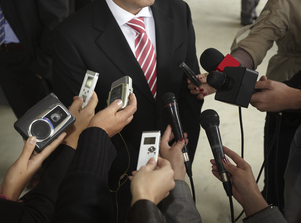 close up of conference meeting microphones and businessman