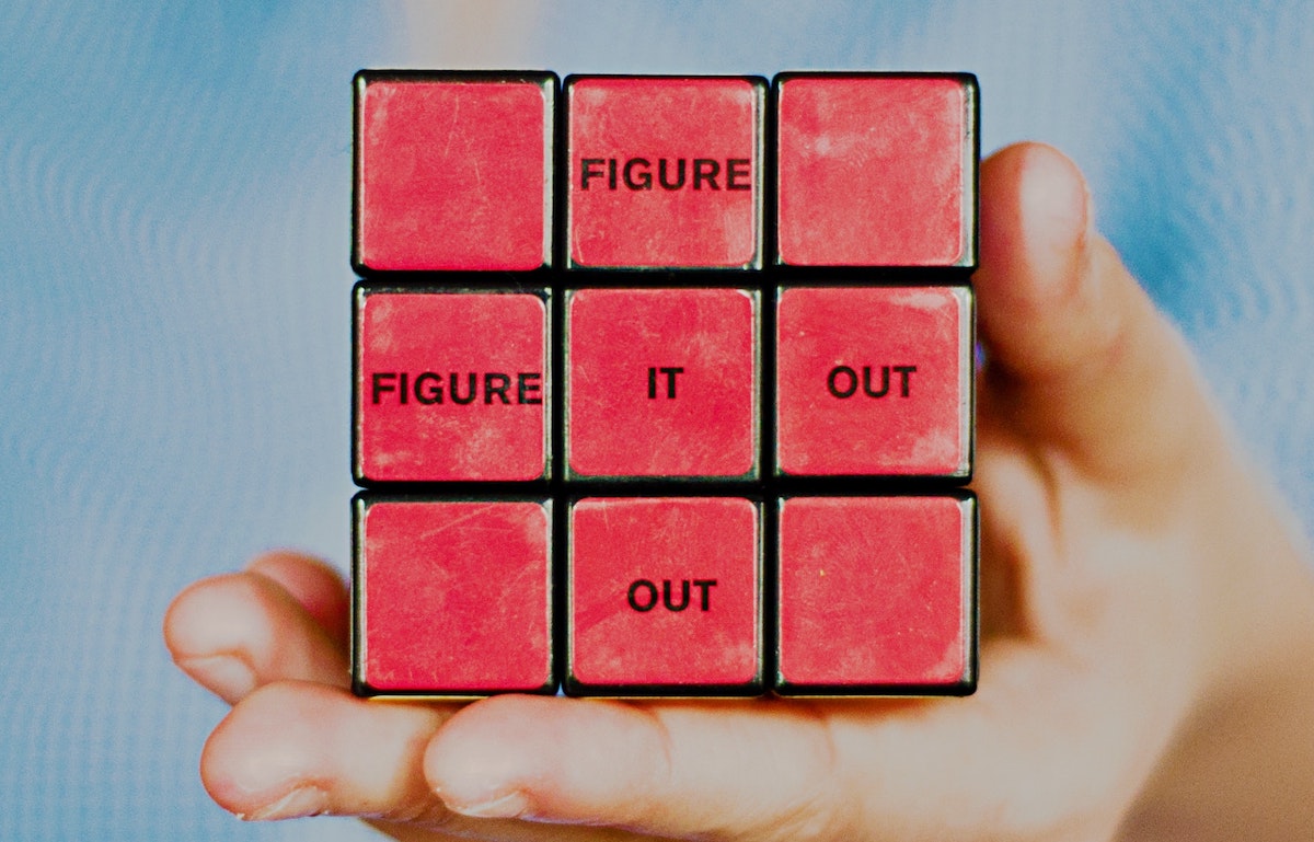 Red side of rubiks cube with text saying 'figure it out'